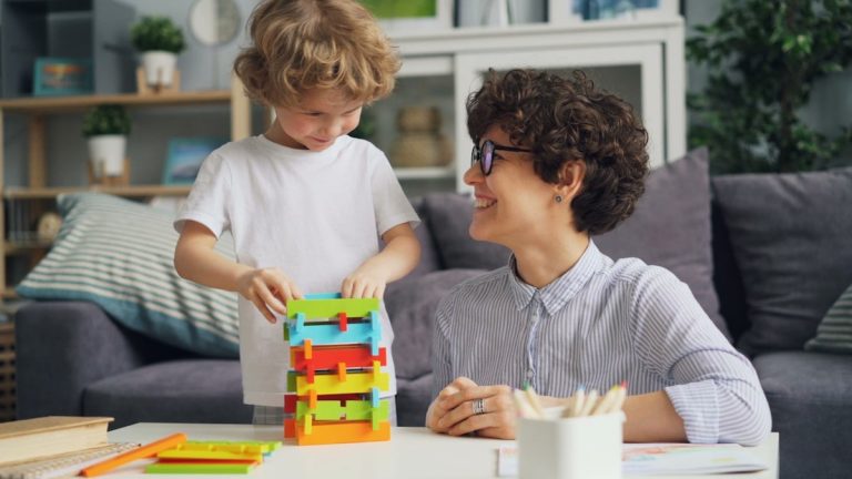 a woman sitting at a table with a child