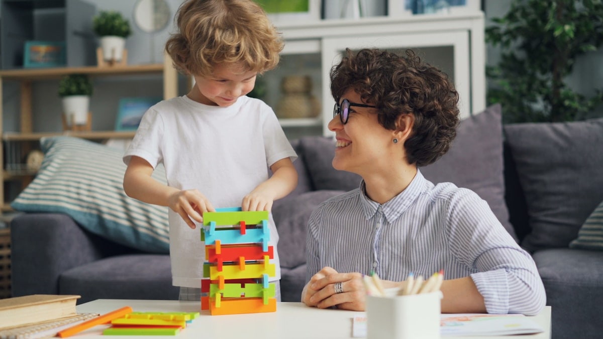 a woman sitting at a table with a child